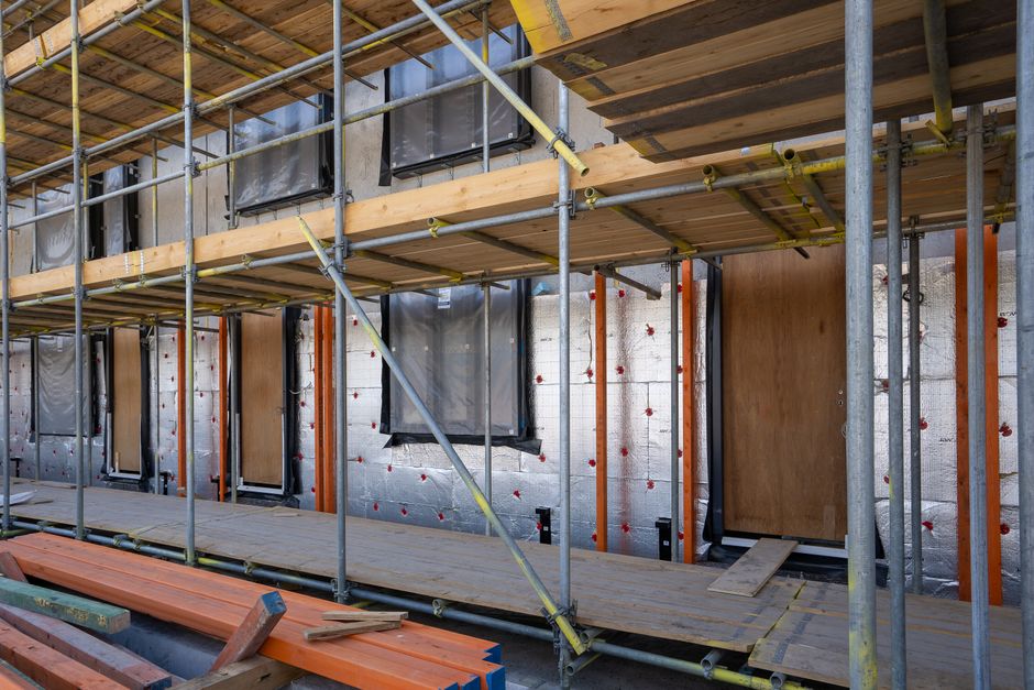 Contractor installing thermal home insulation in an attic